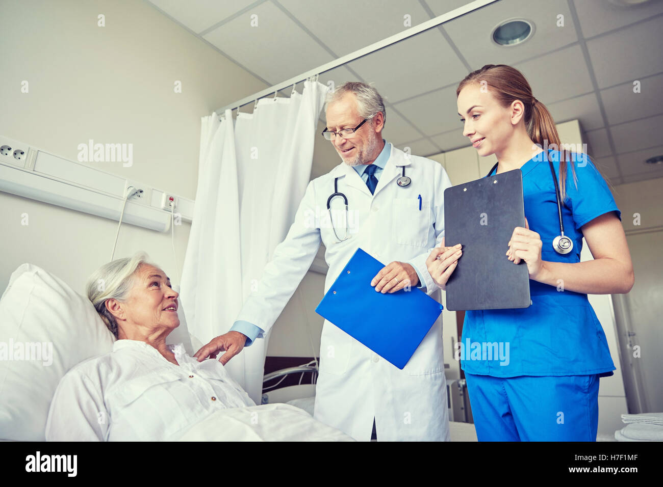 doctor and nurse visiting senior woman at hospital Stock Photo - Alamy