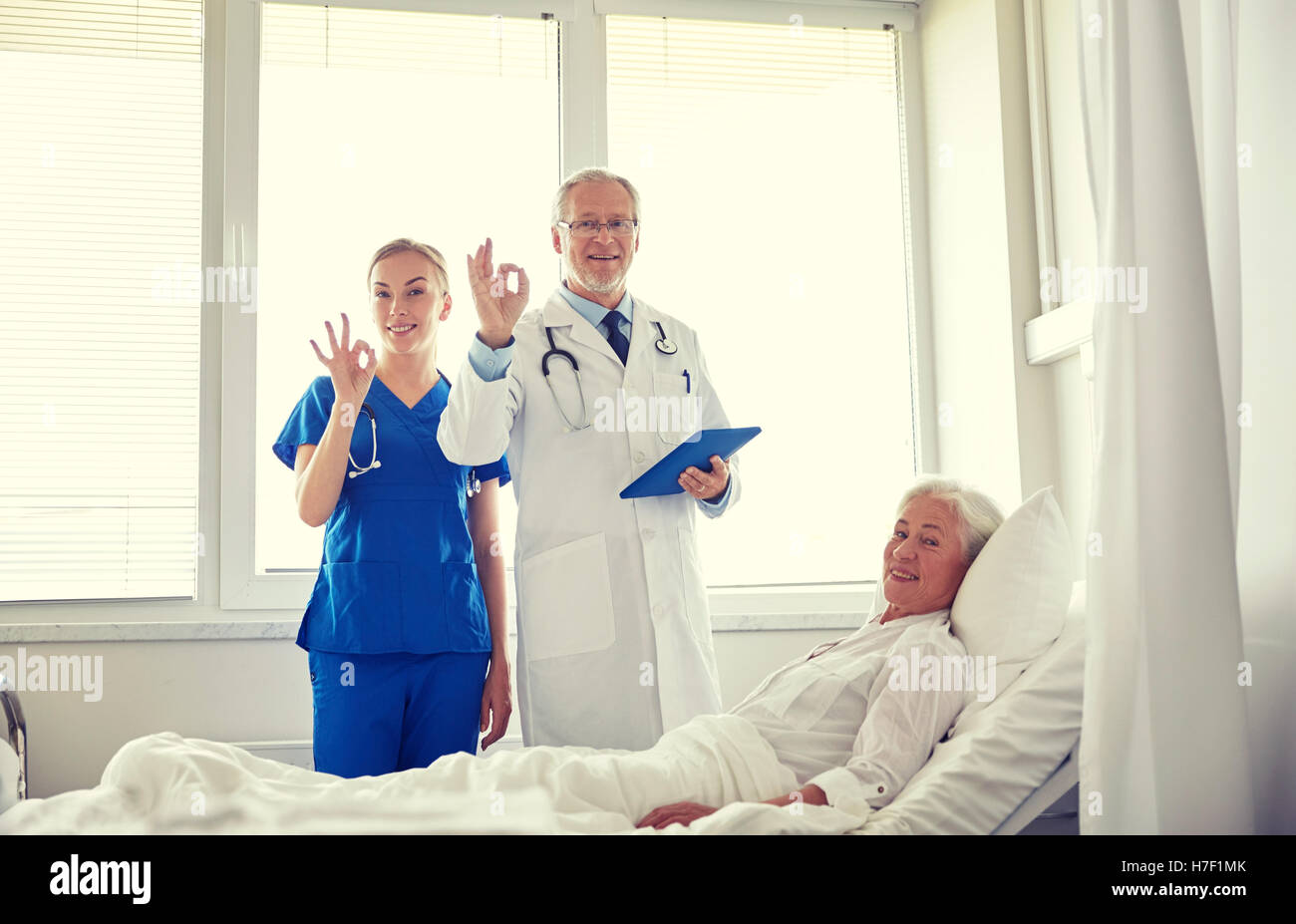 doctor and nurse visiting senior woman at hospital Stock Photo - Alamy