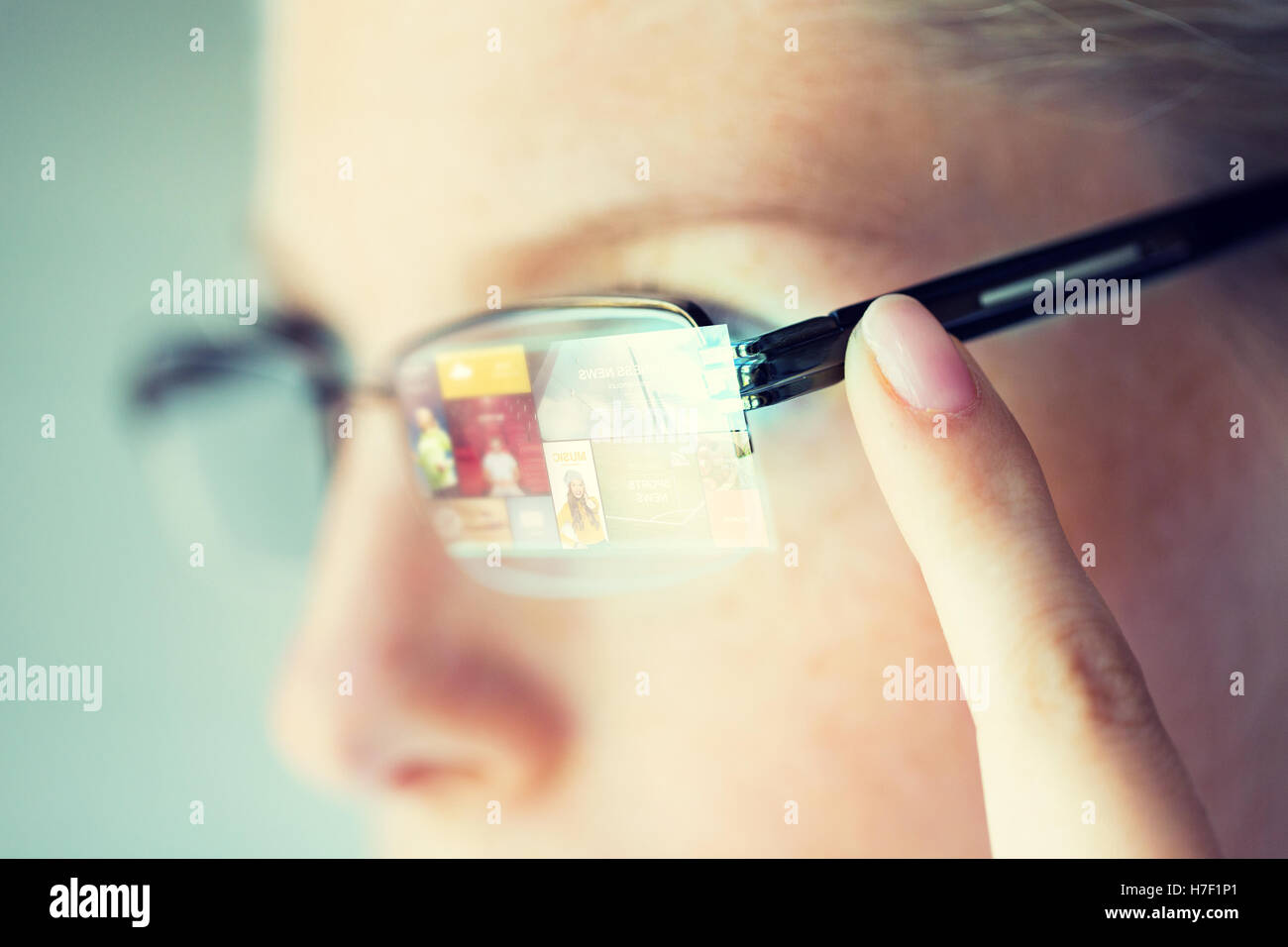 close up of woman in glasses with virtual screen Stock Photo