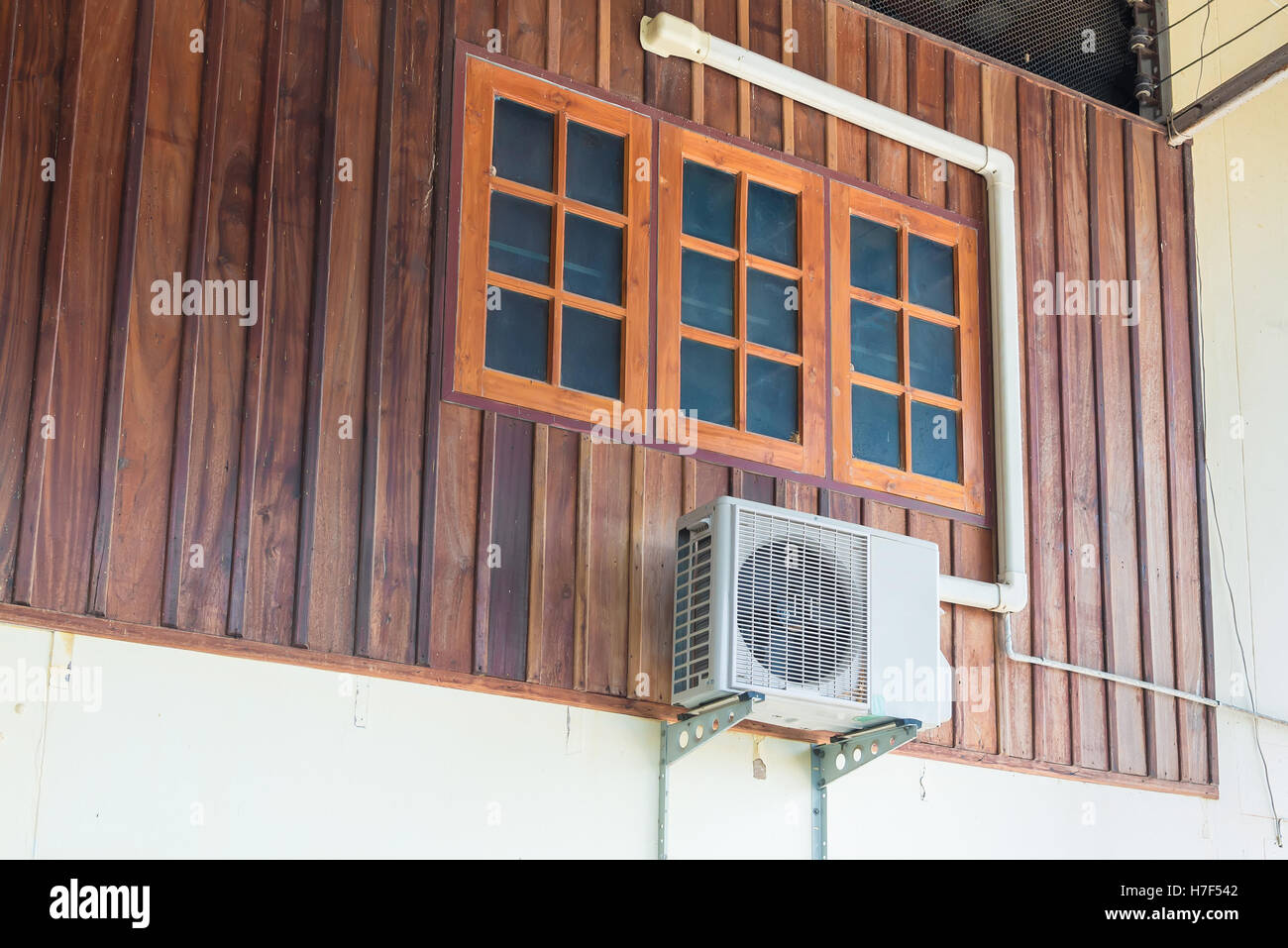 Air conditioning units installed outside the house on wooden wall Stock