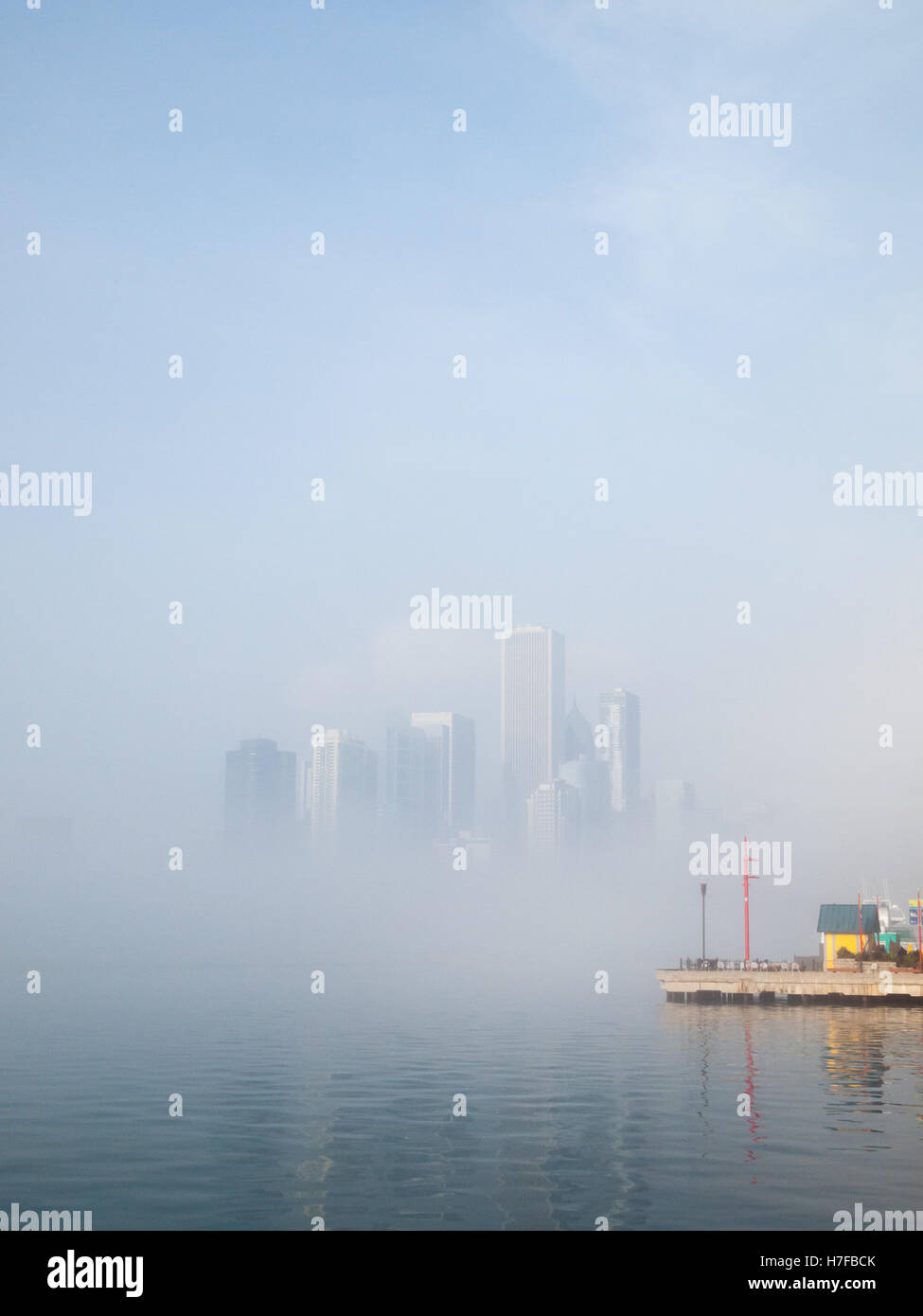 A view of the Chicago skyline, obscured by a heavy advection fog off Lake Michigan, as seen from Navy Pier. Stock Photo