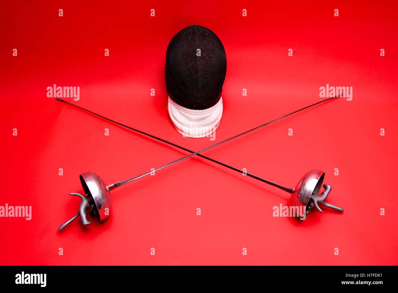 fencing helmet and two epee swords Stock Photo