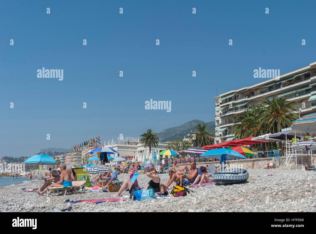 Summer holiday scene at the beach of Menton on the French Riviera in