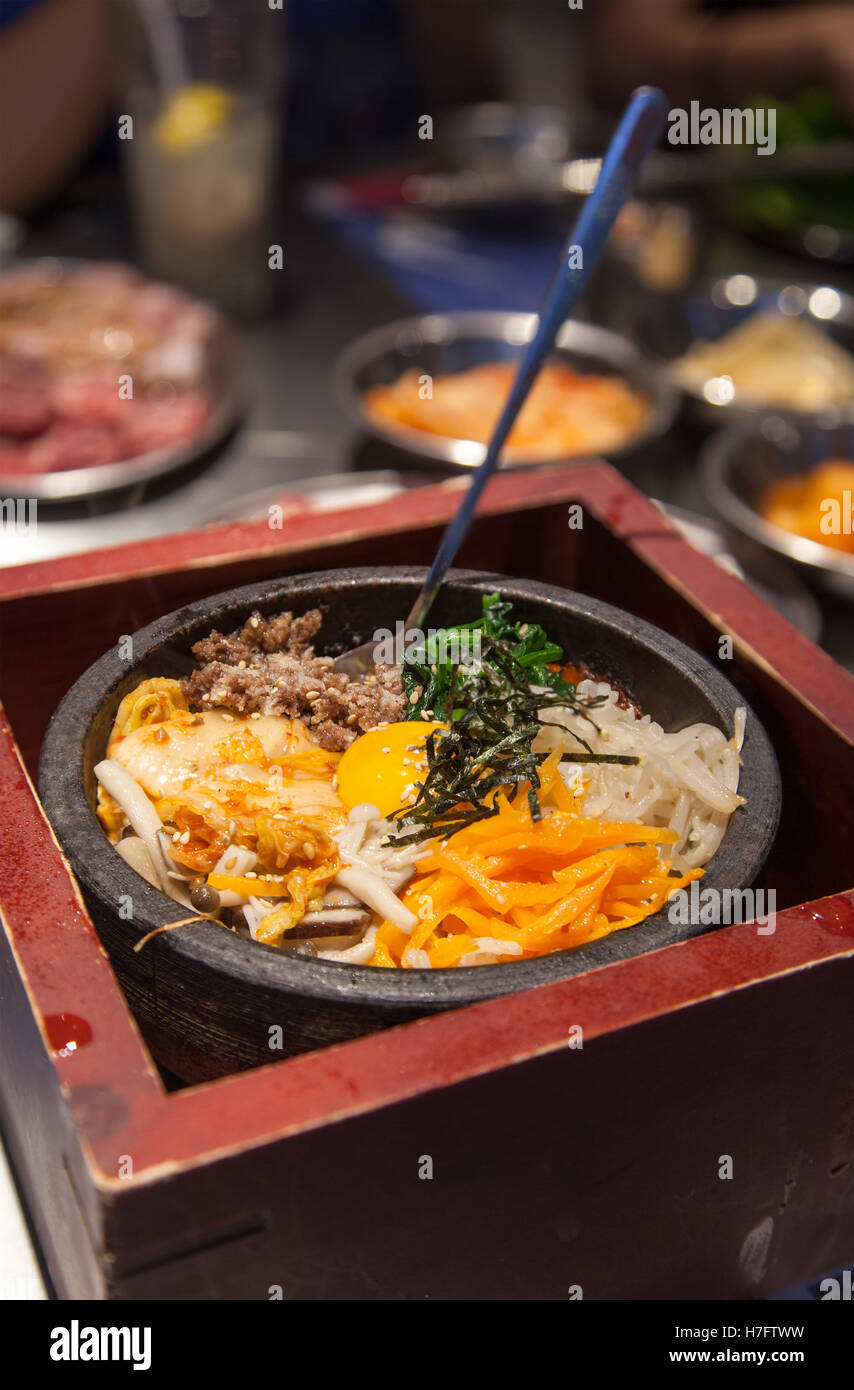 Hot Stone Korean Bi Bim Bap, a traditional signature dish with kimchi vegetables, gochujang chili pepper paste, doenjang. Stock Photo