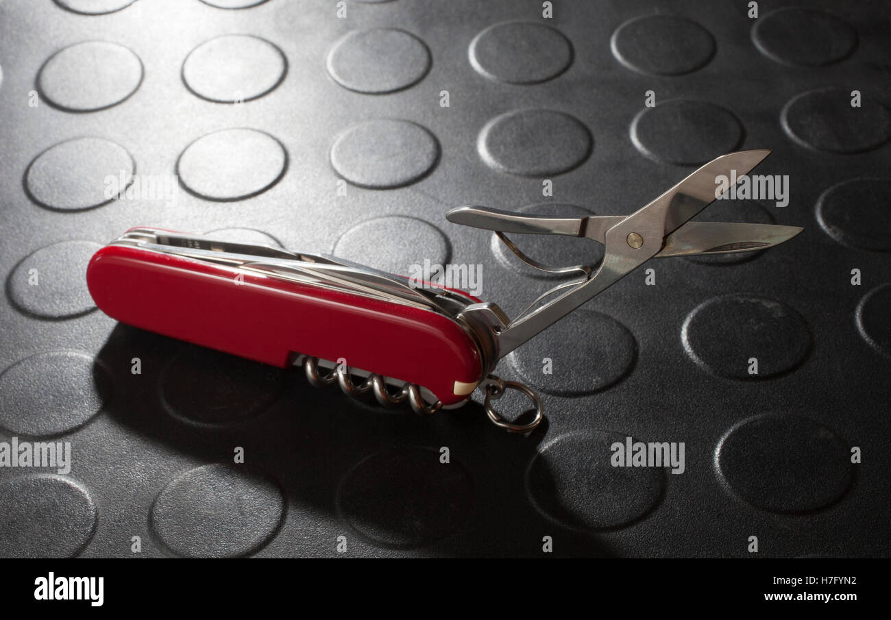 Red pocket knife with scissors that are out for cutting Stock Photo Alamy