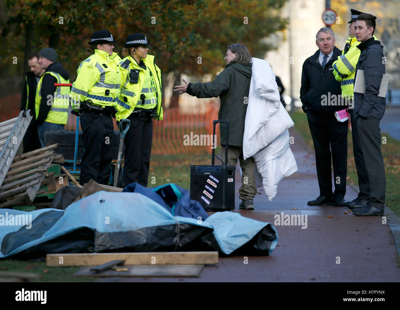 Officers of the court are supported by police as they evict a group of independence campaigners who set up camp on the grounds of the Scottish Parliament in Edinburgh. Stock Photo