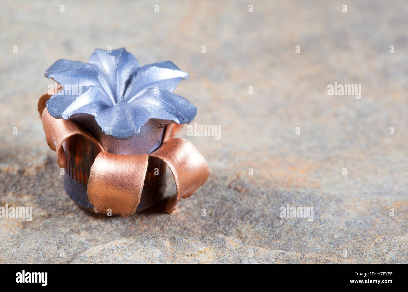 Expanded copper jacketed hollow point bullet after impact Stock Photo