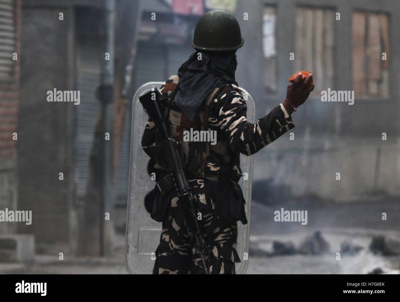 Srinagar, India. 04th Nov, 2016. An Indian trooper attempting to throw a brick towards stone pelters during clashes in Anchar area of Soura Srinagar in Indian Controlled Kashmir. Credit:  Umer Asif/Pacific Press/Alamy Live News Stock Photo