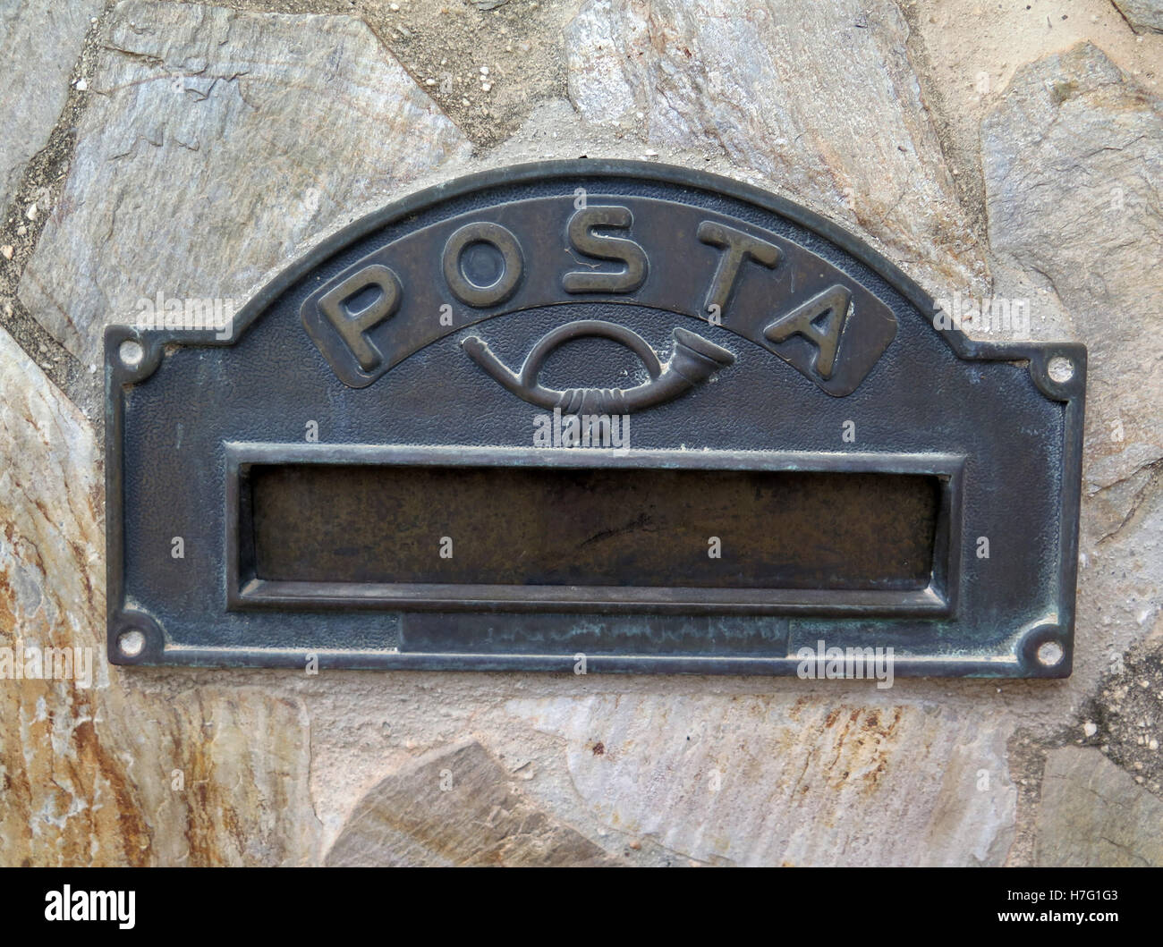 Closeup of metal Spanish letterbox set in patio wall Stock Photo - Alamy