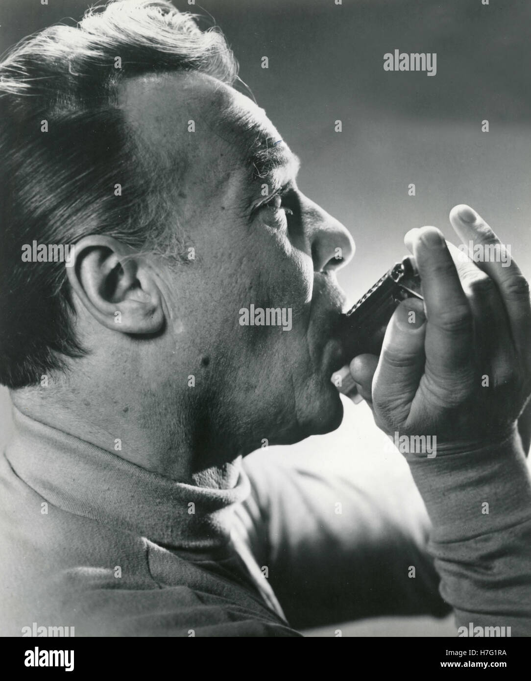 Musician plays the harmonica, Italy Stock Photo Alamy