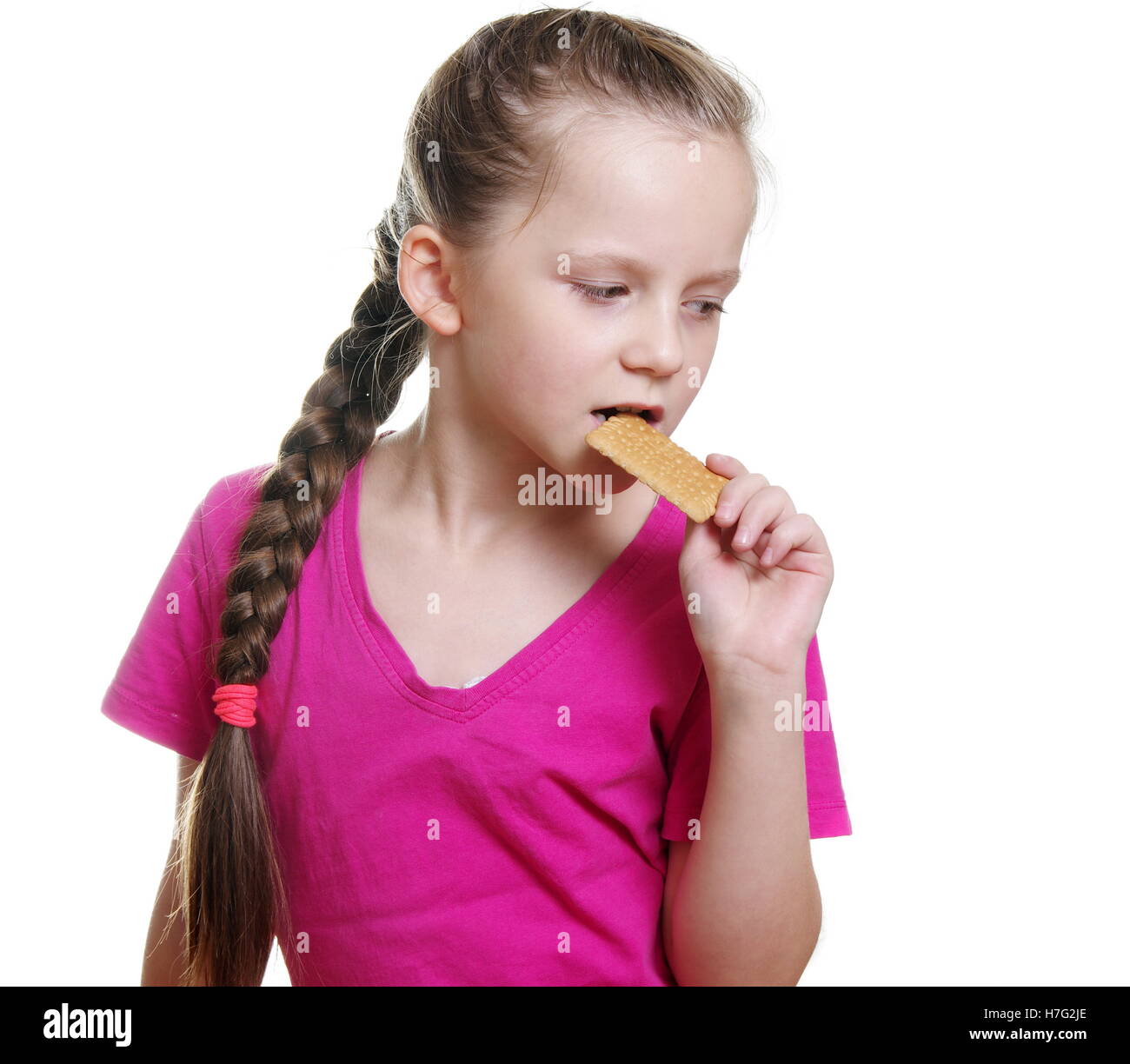 pretty girl eating bisquit Stock Photo - Alamy