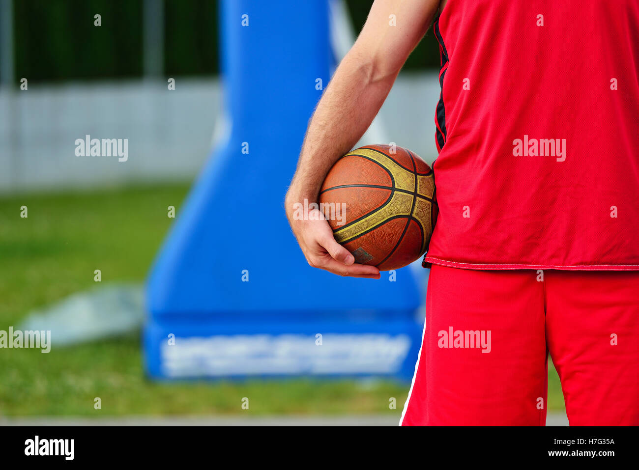 Young Streetball player with basketball ball outdoors Stock Photo Alamy