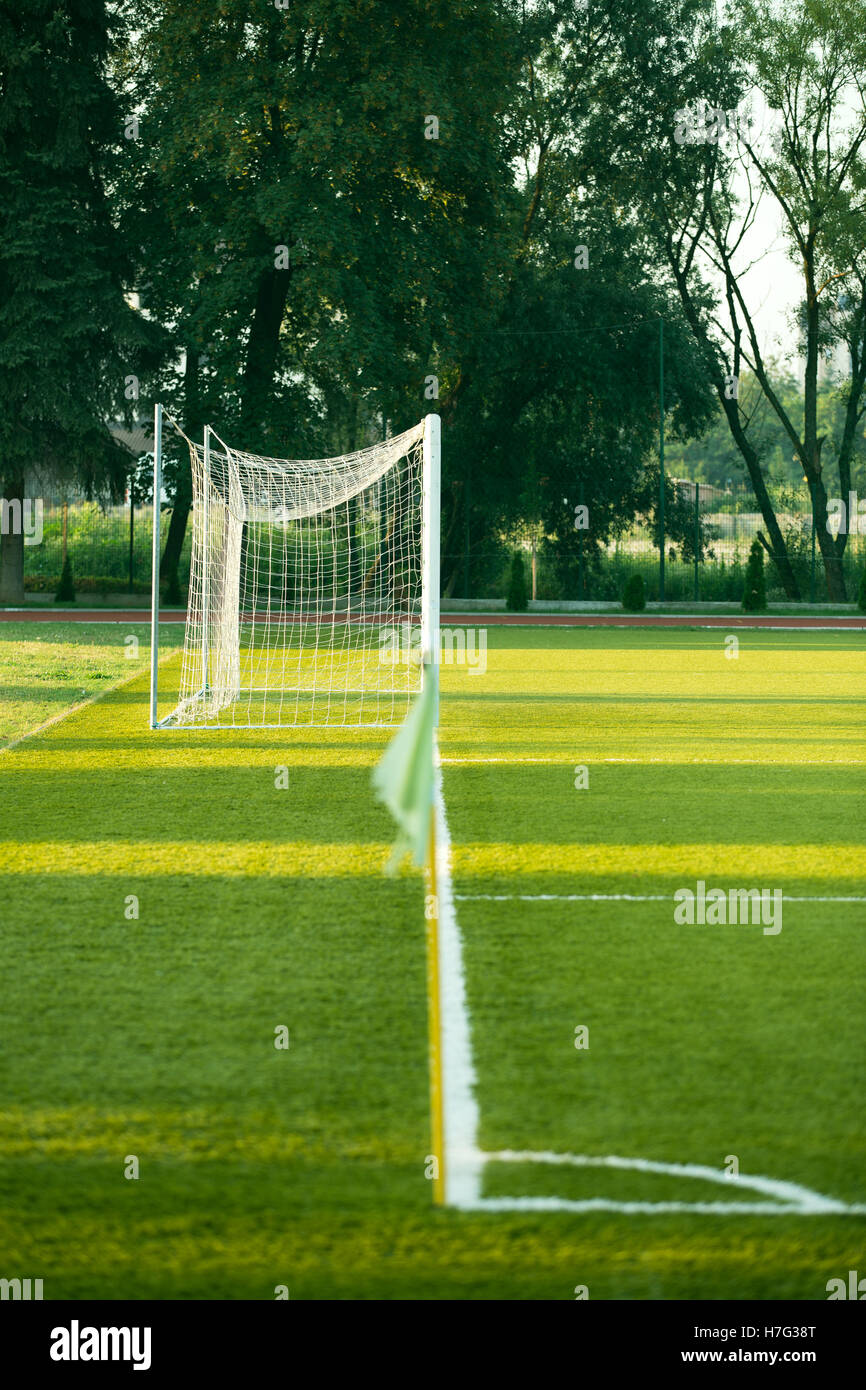 left side view of standard goal and net in football pitch or soccer field. Stock Photo