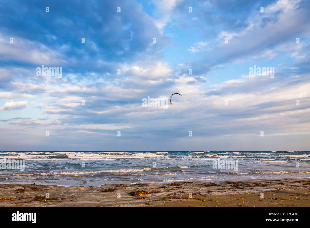 Kitesurfing in a cloudy autumn day. Lady's Mile beach in Limassol, Cyprus Stock Photo