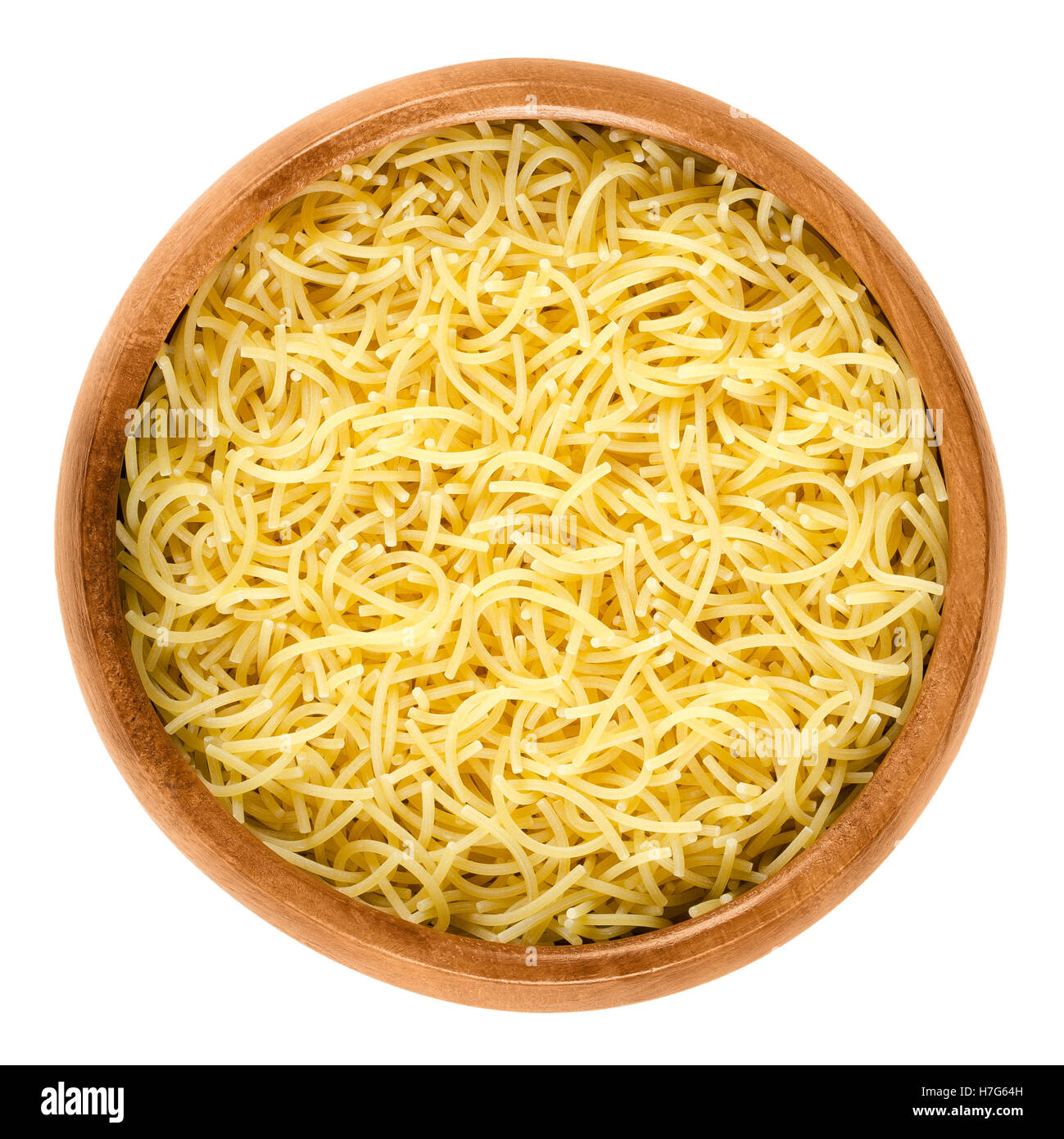 Filini short cut pasta in wooden bowl. Italian miniature noodles with