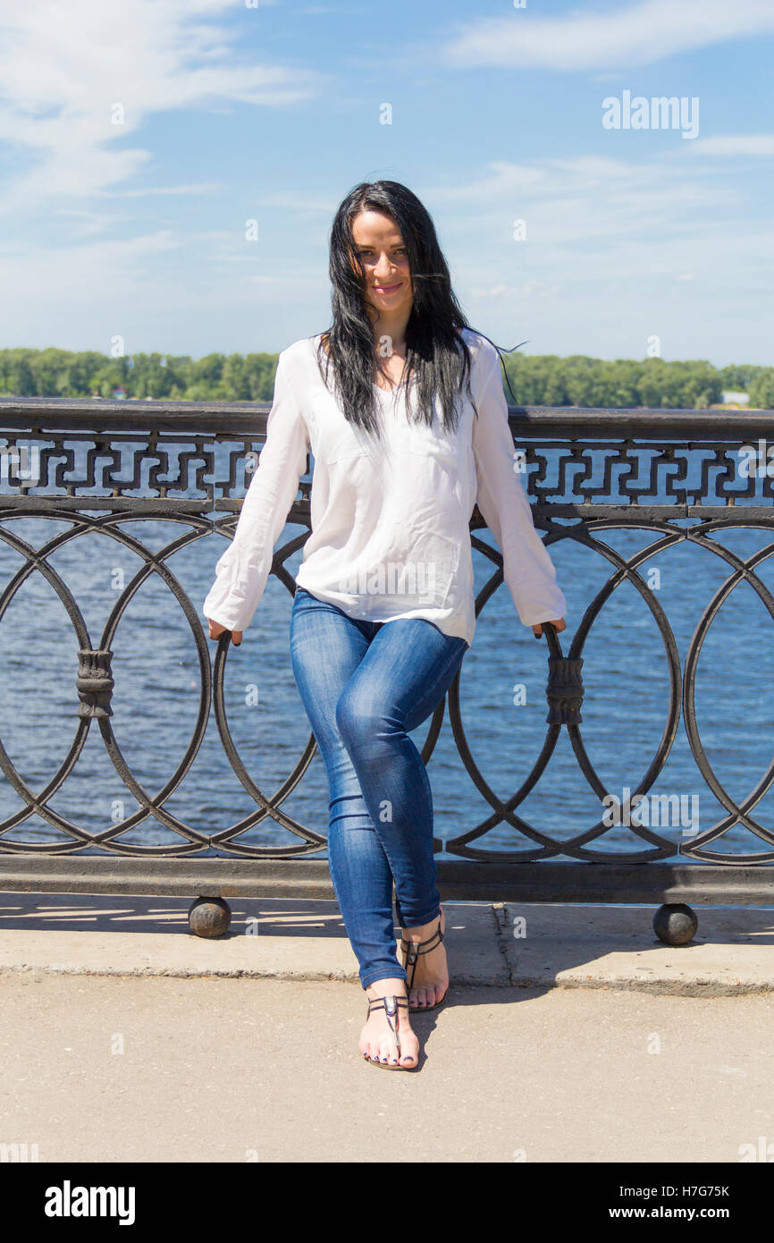 Standing young Caucasian woman on river background Stock Photo - Alamy