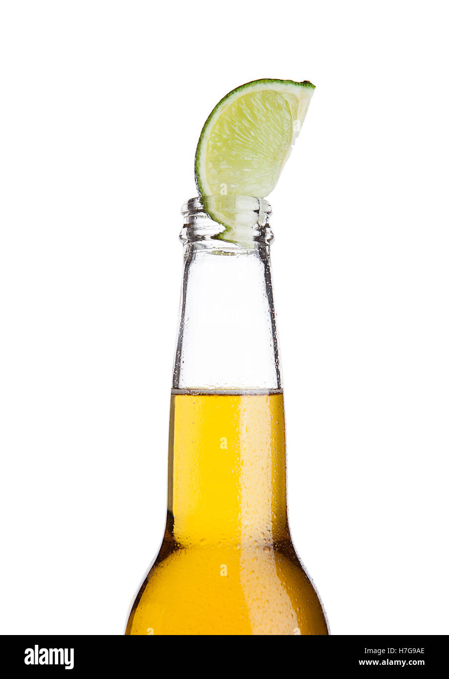 Mexican beer bottle with lime slice and frost on white background Stock