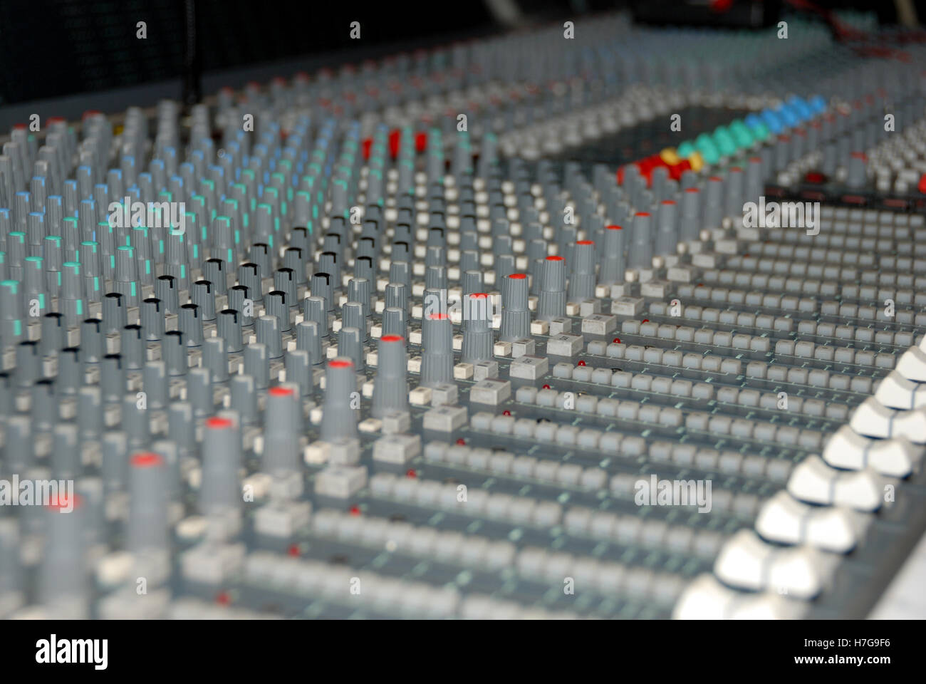 Audio mixing console in a recording studio. Faders and knobs of a sound
