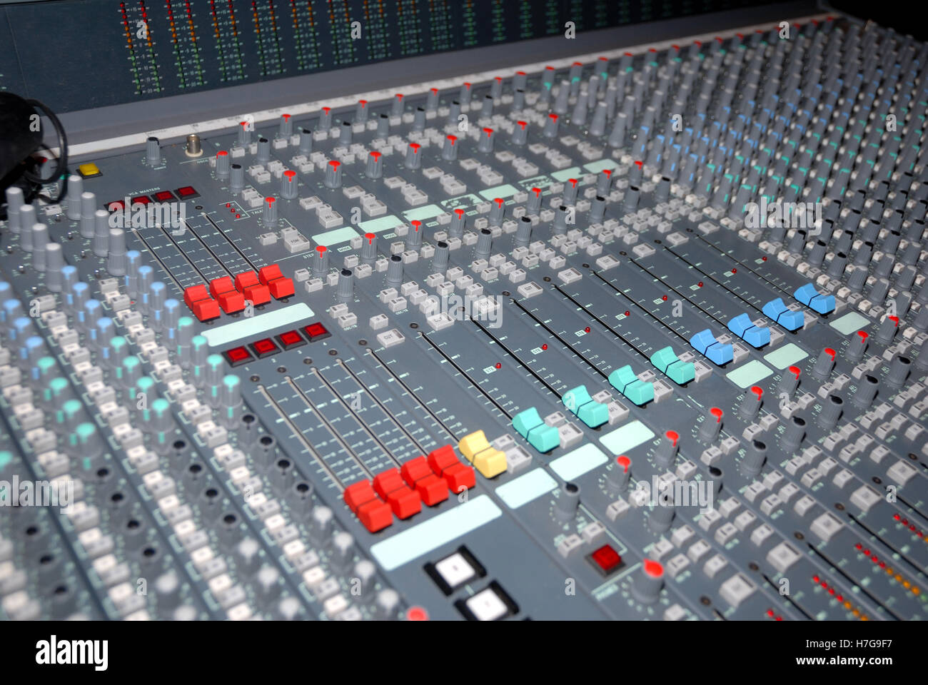 Audio mixing console in a recording studio. Faders and knobs of a sound