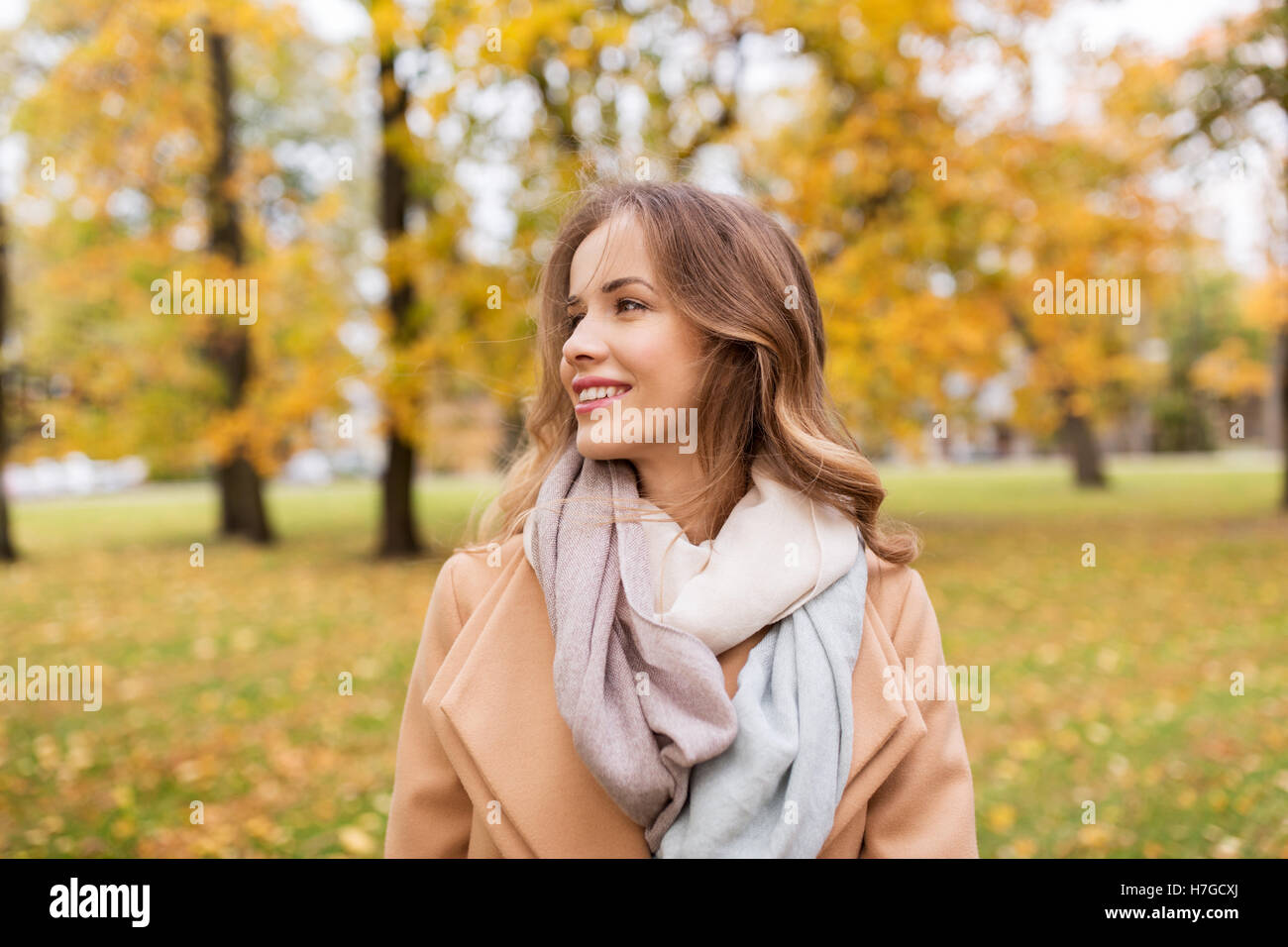 beautiful happy young woman smiling in autumn park Stock Photo - Alamy