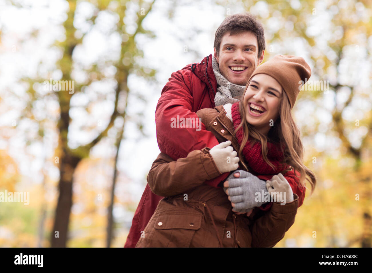 happy young couple hugging in autumn park Stock Photo - Alamy