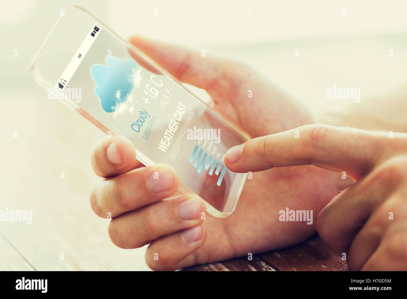 close up of male hand with weather cast smartphone Stock Photo