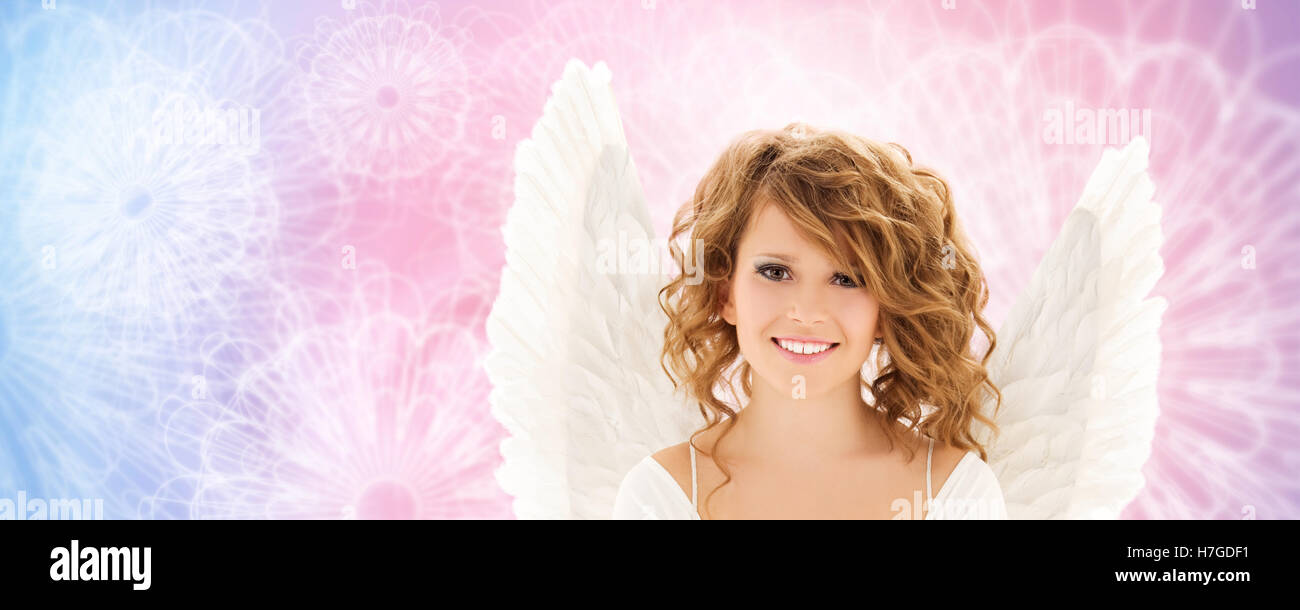 happy young woman or teen girl with angel wings Stock Photo