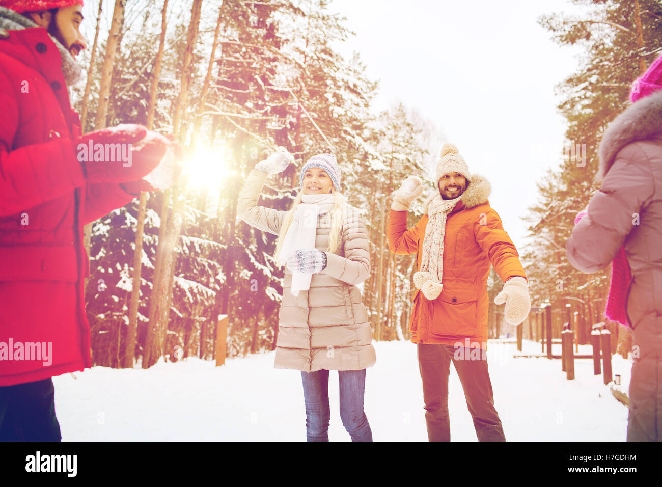 happy friends playing snowball in winter forest Stock Photo - Alamy