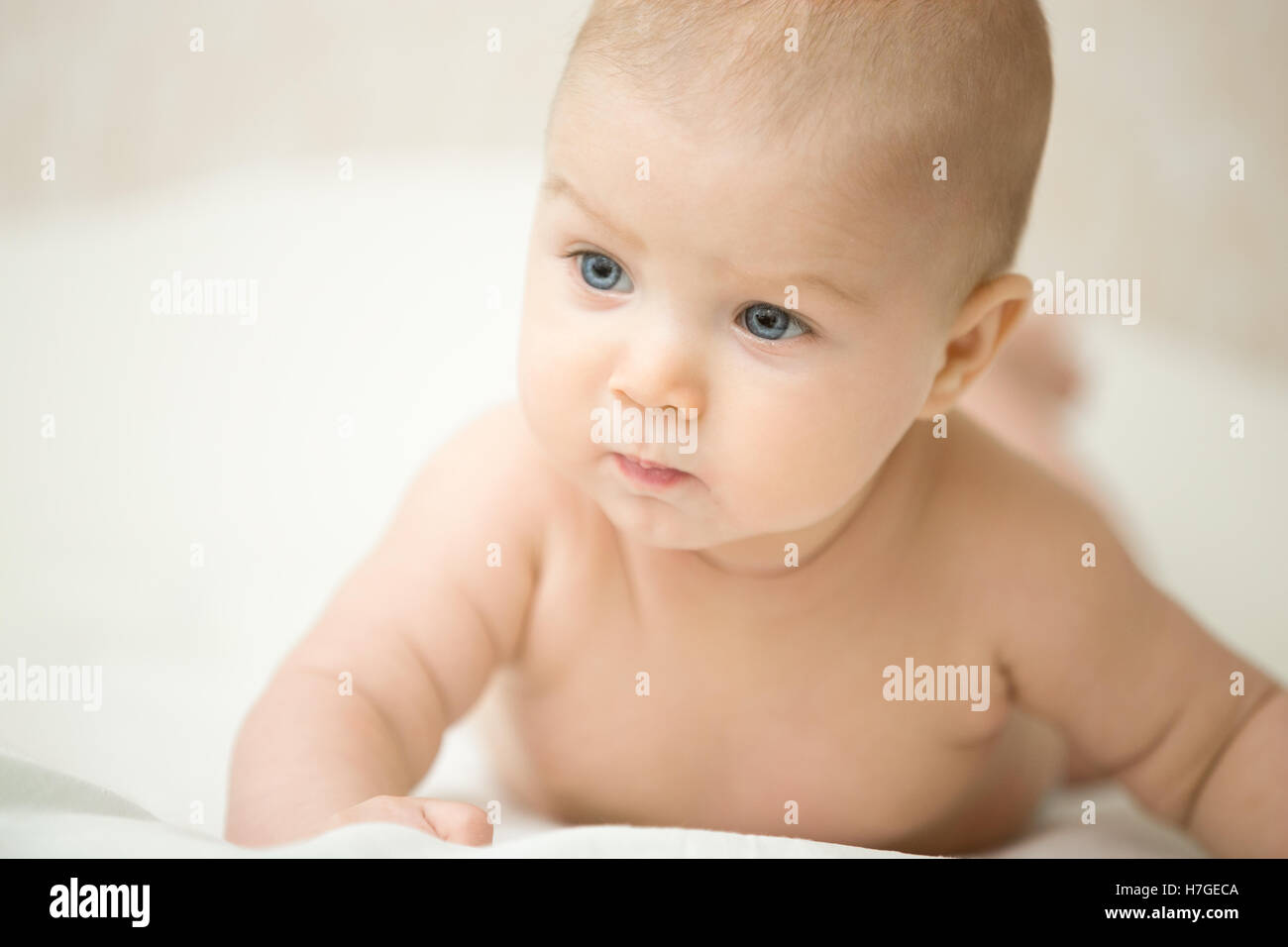 Portrait of a cute child turnig his head, looking serious Stock Photo