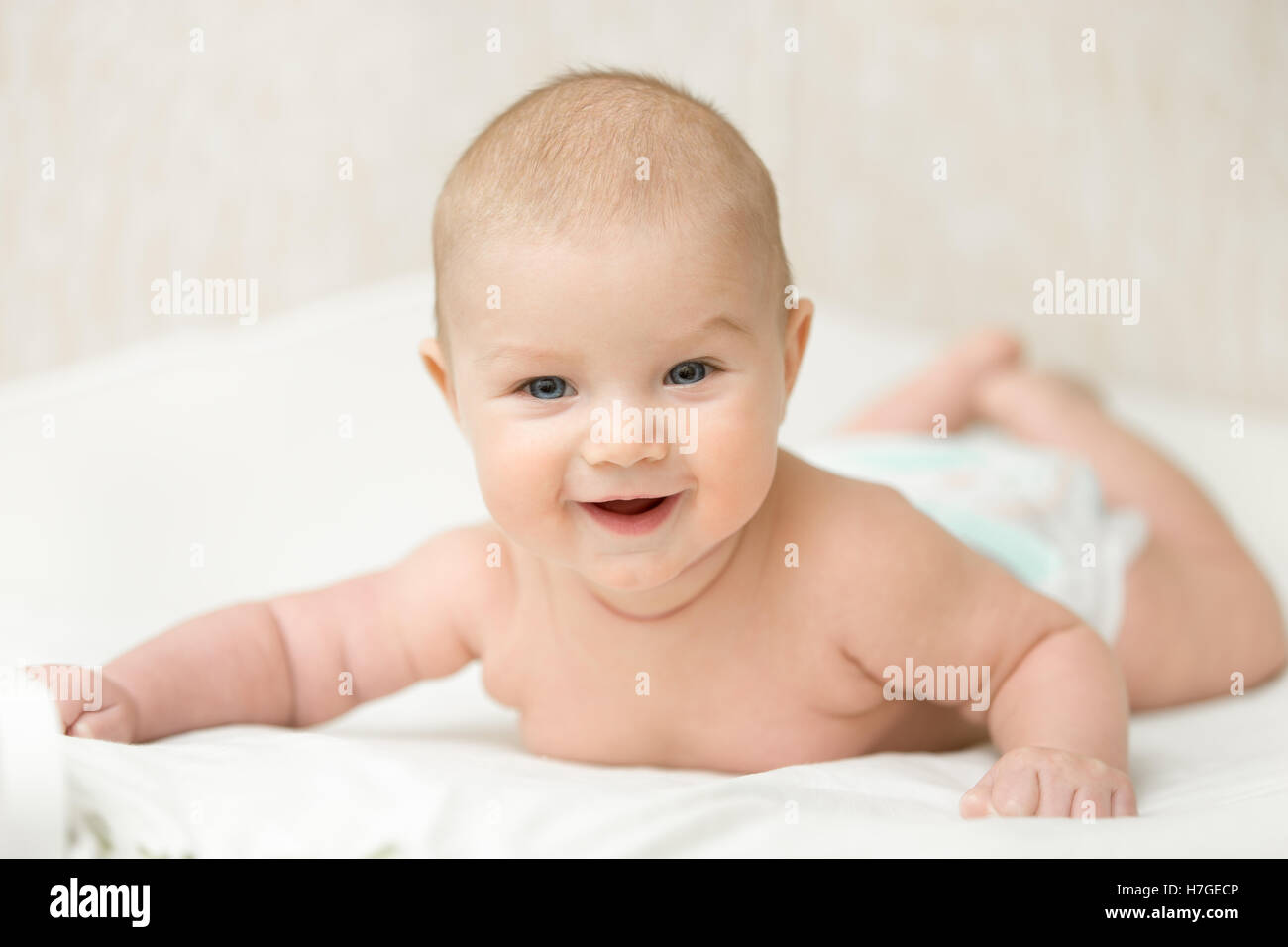 Funny infant baby, holds head up Stock Photo