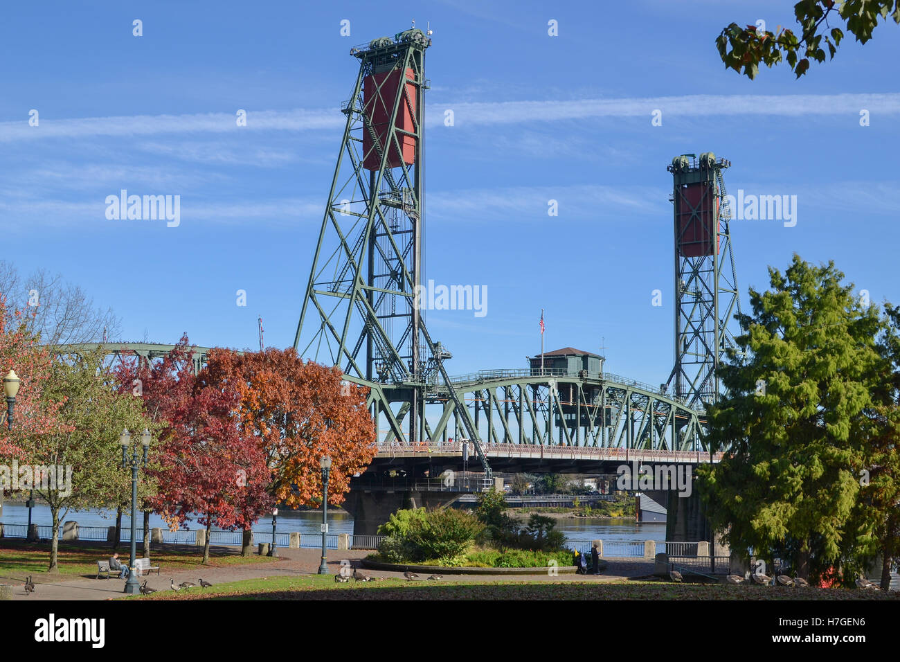 View of a portion of the Steel bridge from Portland’s Governor Tom McCall Waterfront Park on sunny Autumn day. Stock Photo