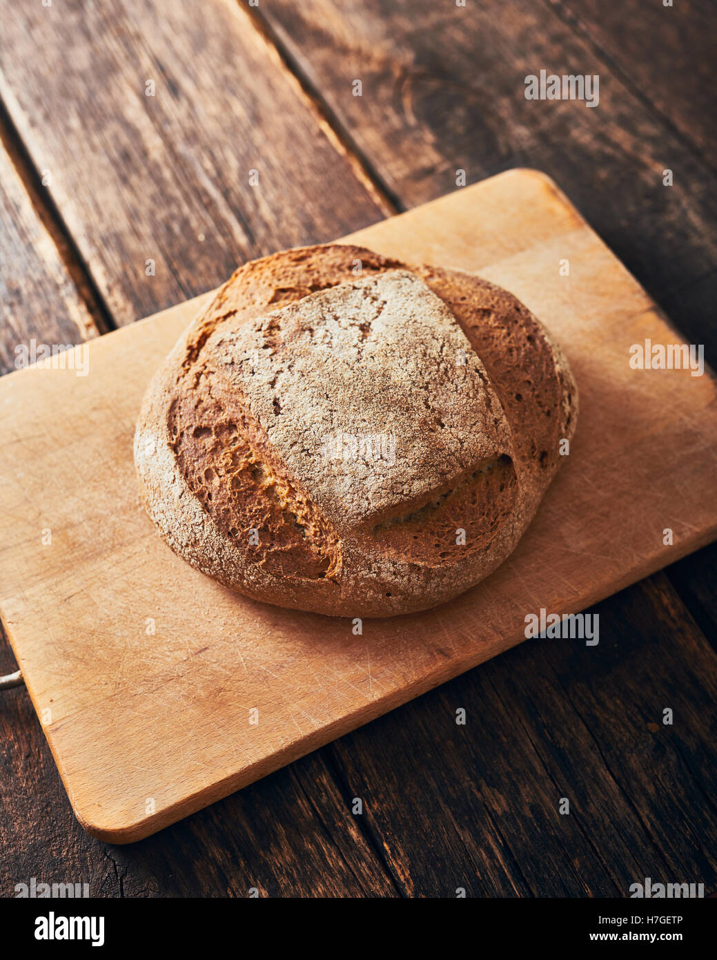 Homemade bread on wooden cutting board Stock Photo - Alamy