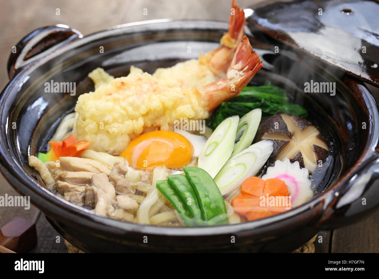 nabeyaki udon, japanese hot pot noodle on wooden background Stock Photo