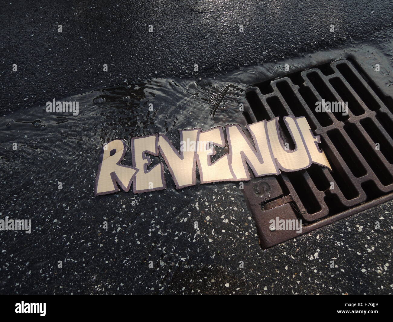 The text "Revenue" is flushed down the drain Stock Photo Alamy