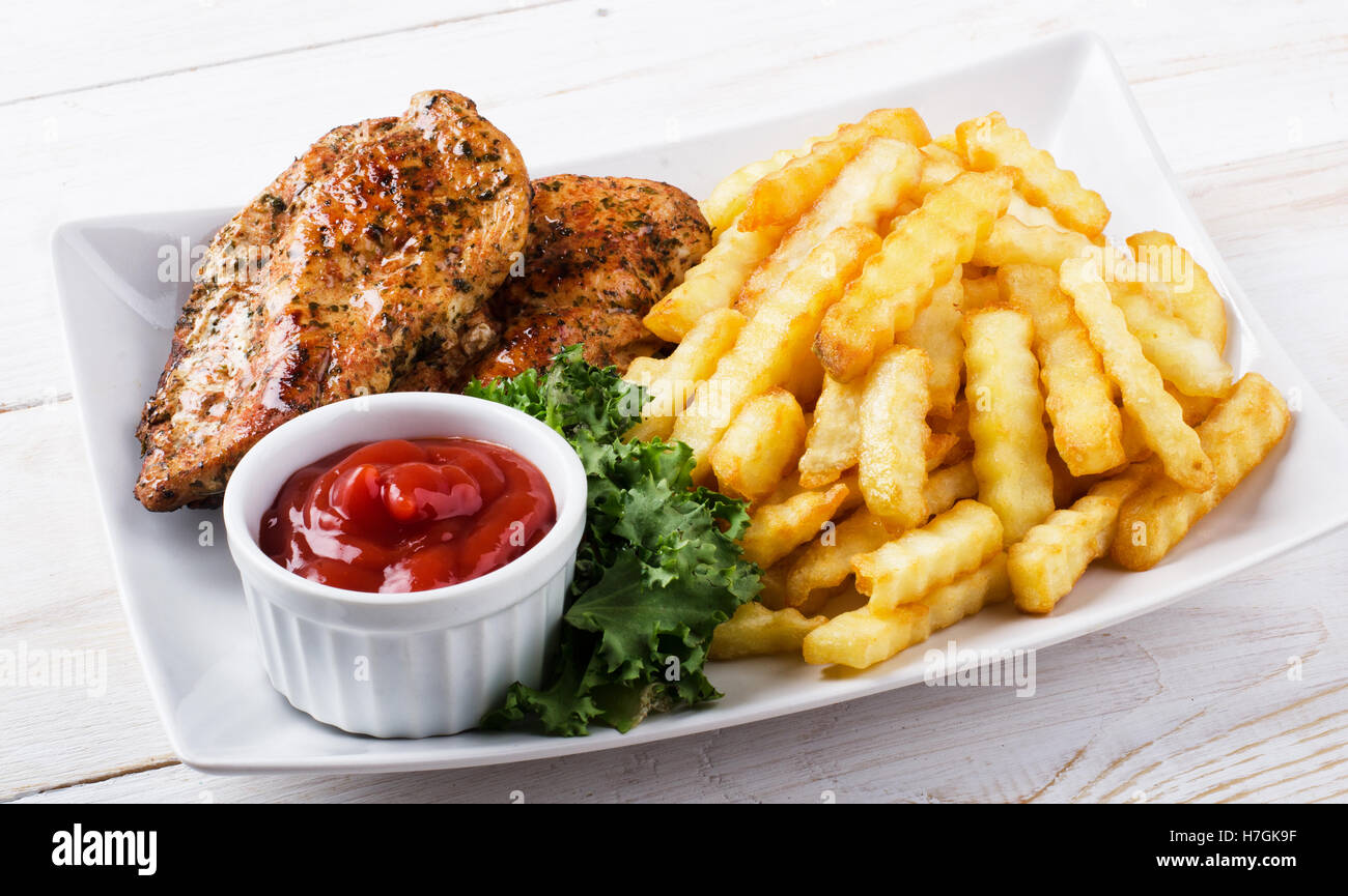 Grilled chicken steak, french fries and salad Stock Photo Alamy