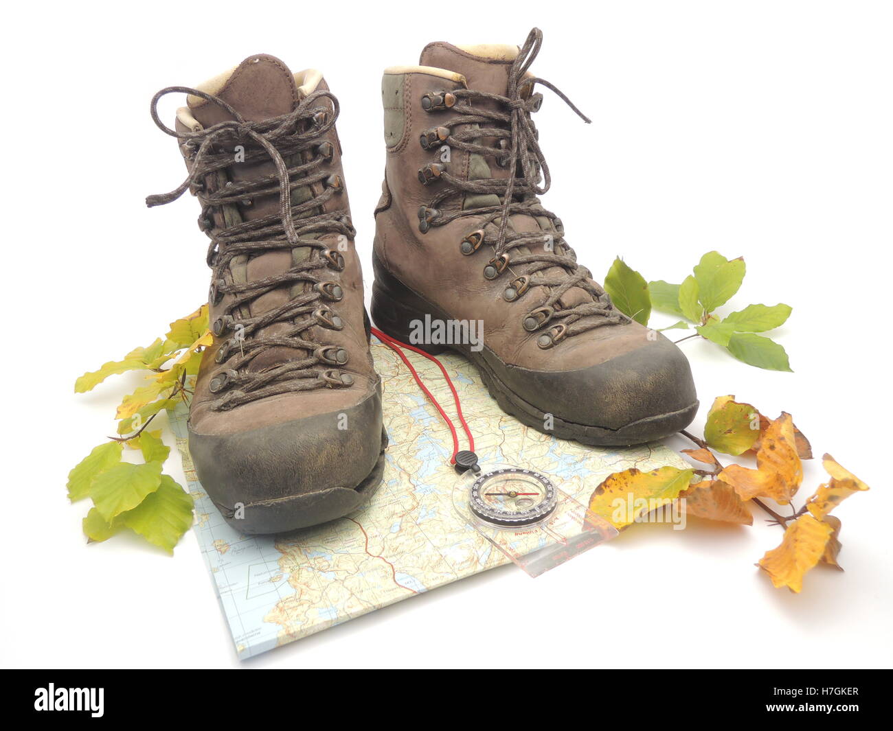 Hiking boots with map, compass and fall leaves Stock Photo Alamy