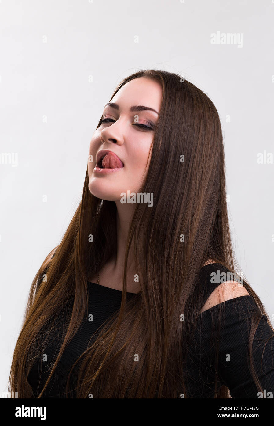 Emotion series of young and beautiful ukrainian girl - tongue licking lips Stock Photo