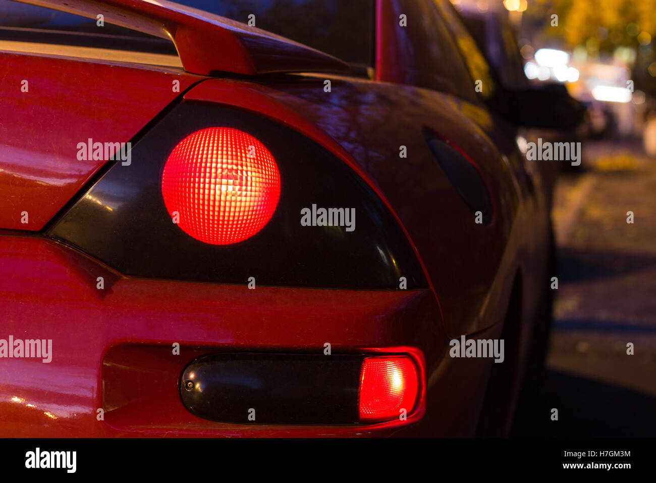 Red sports car glowing Back Lights Stock Photo