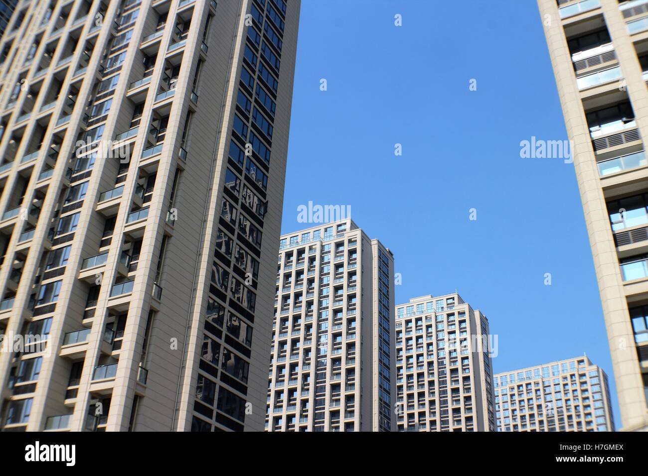 Apartment buildings on blue sky Stock Photo - Alamy