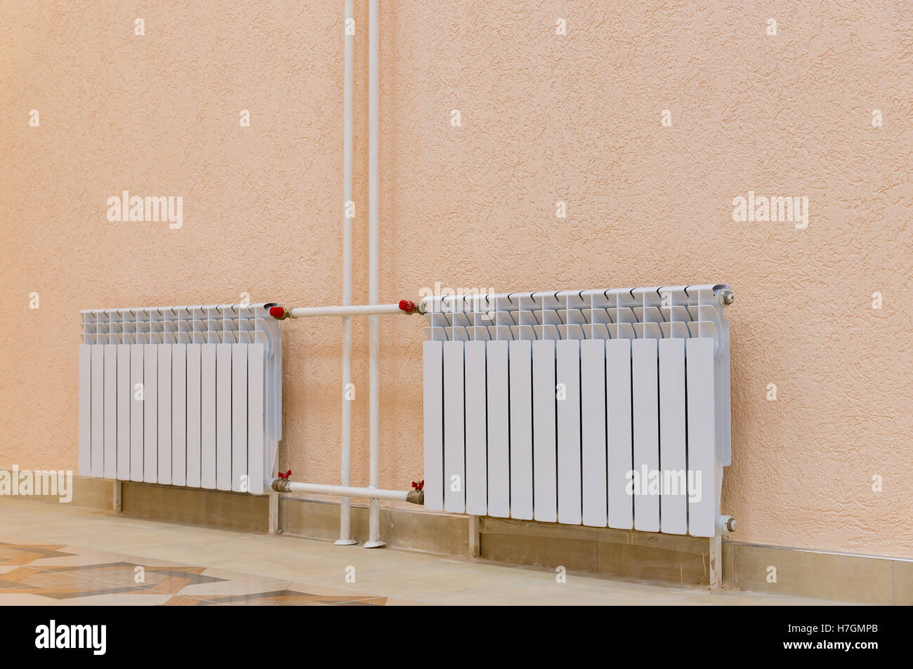 White radiators on pink wall in building Stock Photo Alamy
