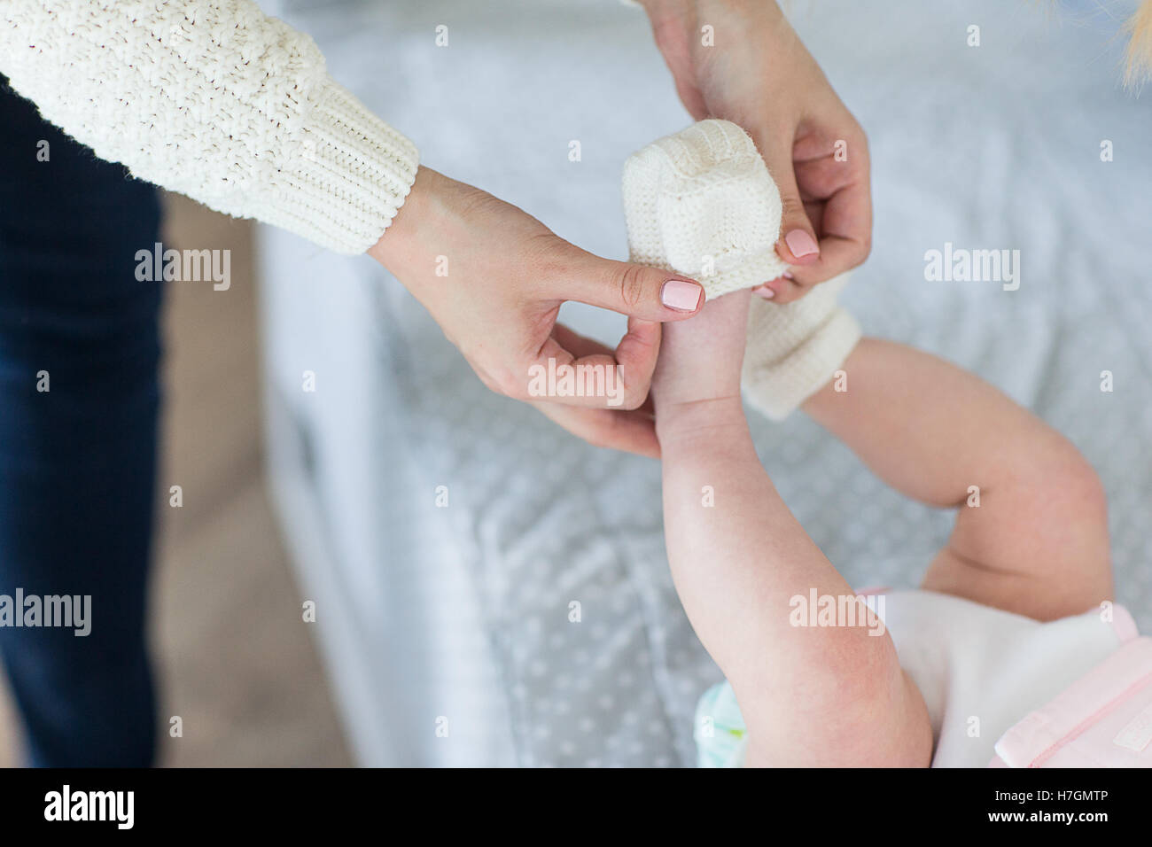 Mom puts clothes on the baby. Woman puts her baby Stock Photo Alamy