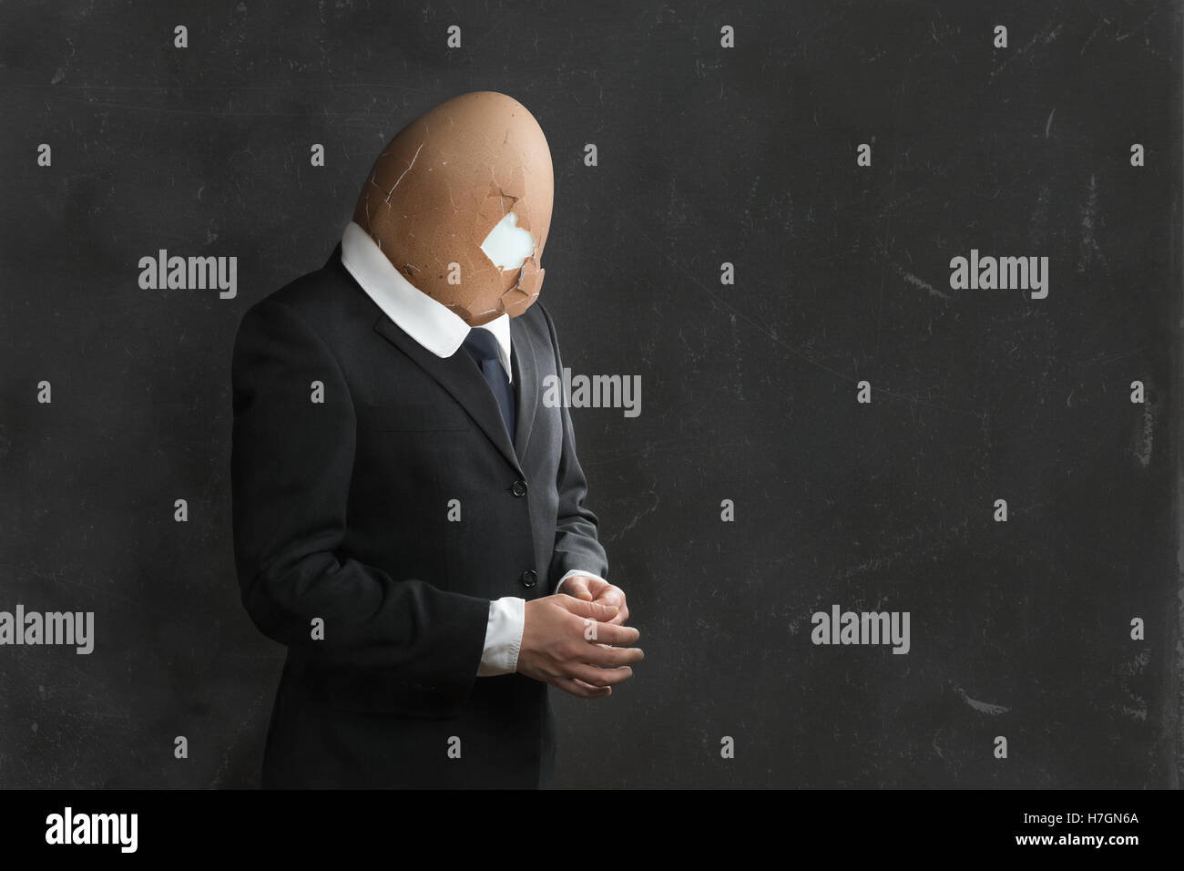 Businessman with broken Egghead and Suit Stock Photo