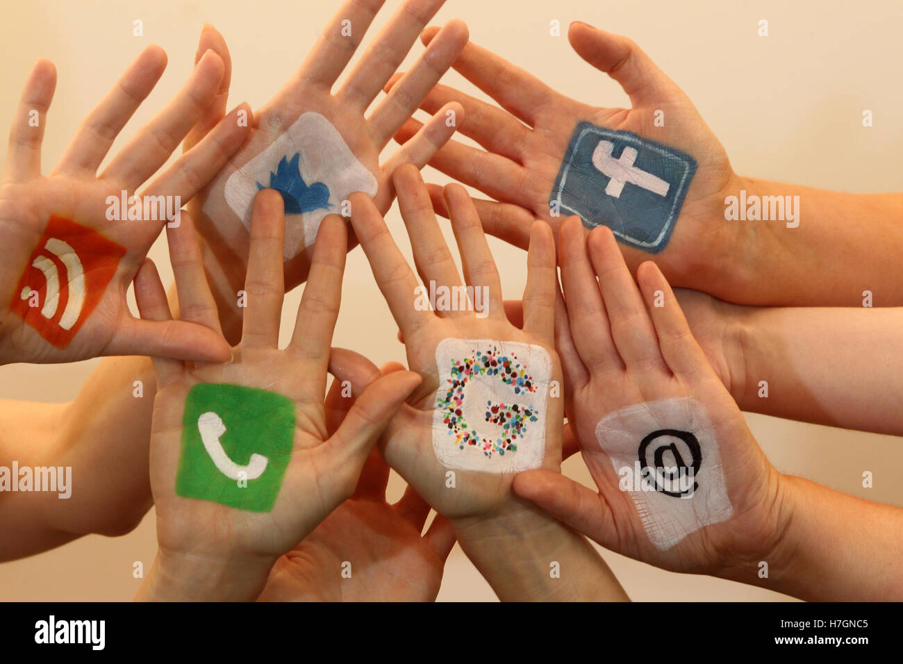 Hands together with social media logos Stock Photo - Alamy