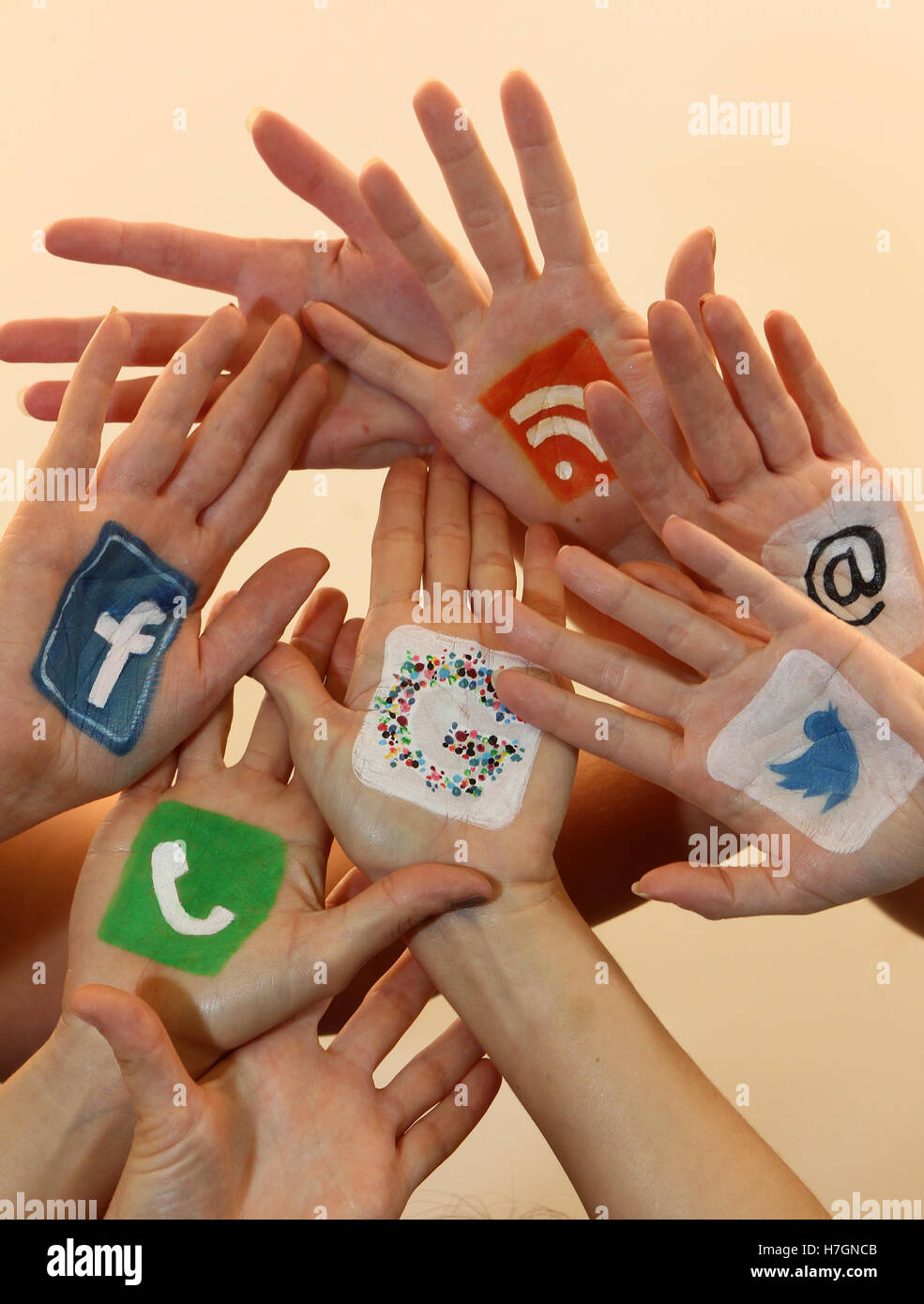 Hands together with social media logos Stock Photo - Alamy