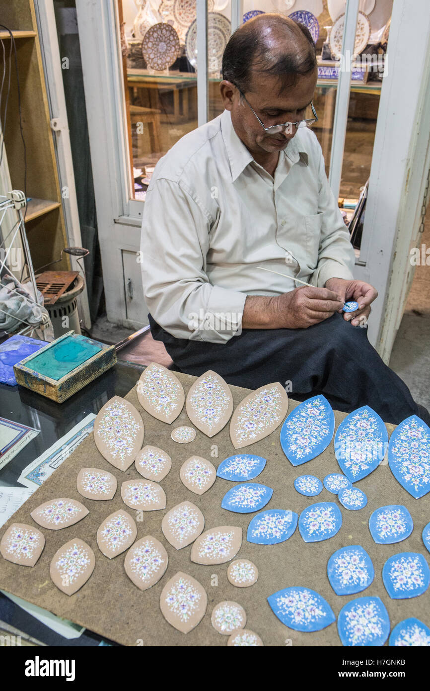 iranian man painting in shop Stock Photo