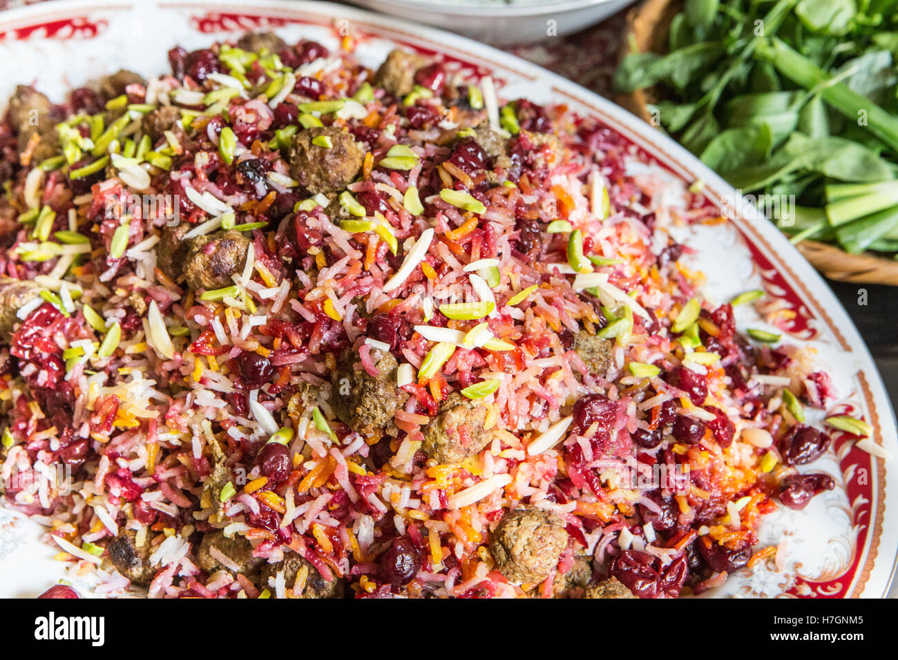 close up of iranian rice dish with meatballs pistachios and sour