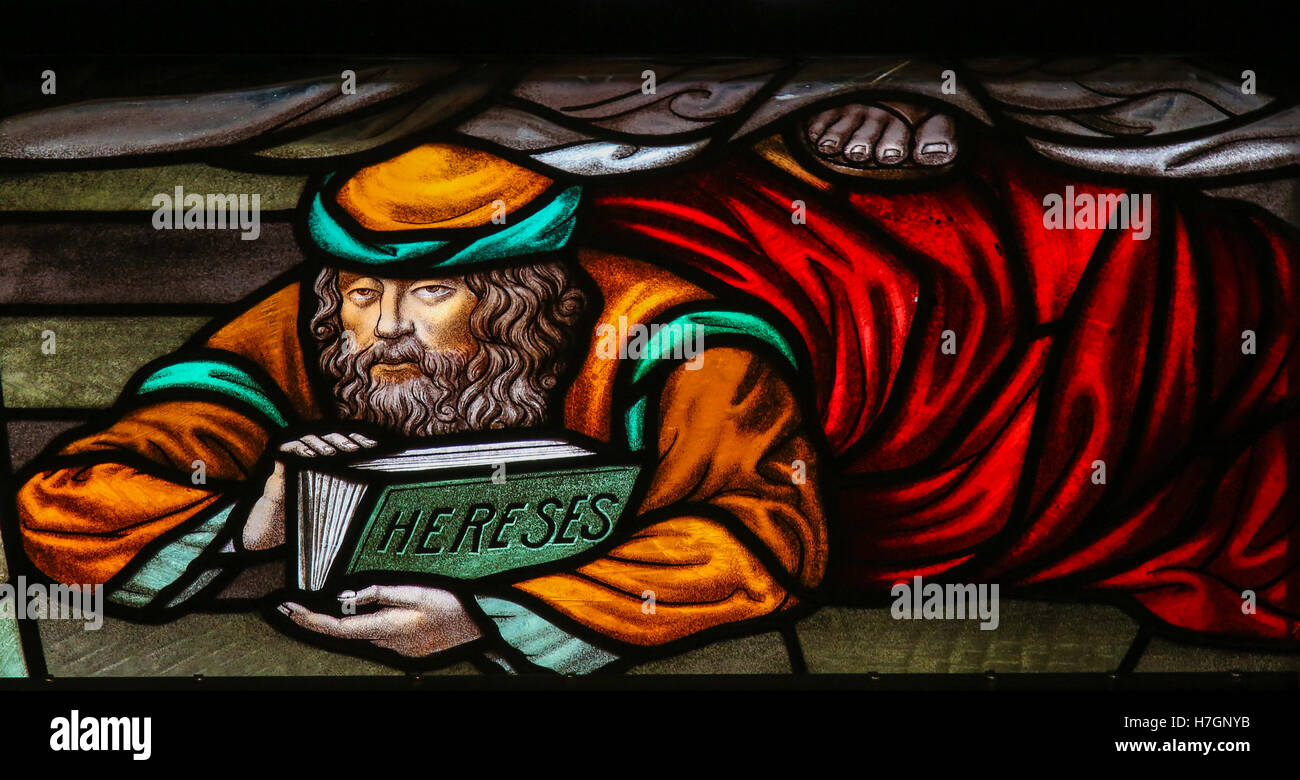 Stained Glass window depicting a heretic, in the Cathedral of Saint Rumbold in Mechelen, Belgium. Stock Photo