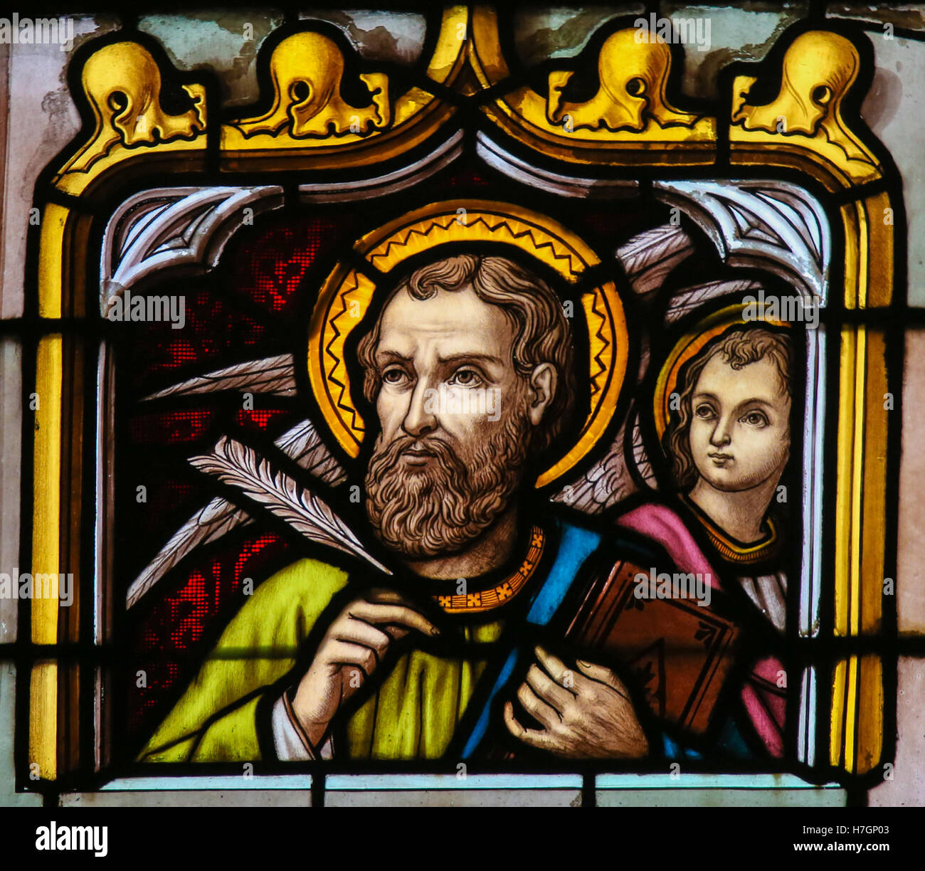 Stained Glass window depicting Saint Matthew the Evangelist, in the Cathedral of Saint Rumbold in Mechelen, Belgium. Stock Photo