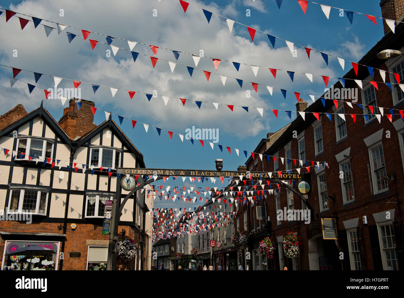 Bunting above the busy St John Street (A515) in Ashbourne, Derbyshire, England, UK Stock Photo