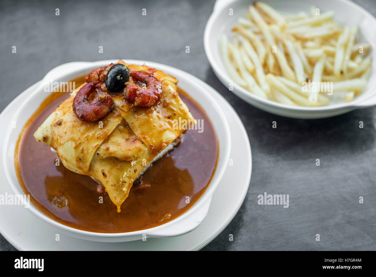 famous francesinha traditional meat cheese and spicy sauce grilled sandwich of porto portugal Stock Photo